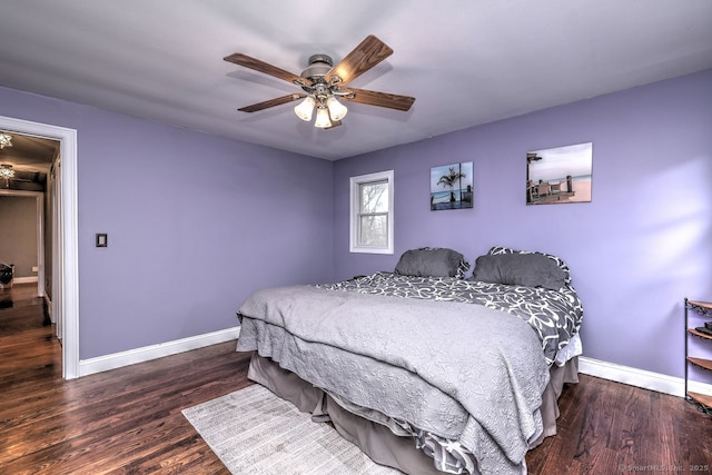 bedroom with dark hardwood / wood-style floors and ceiling fan