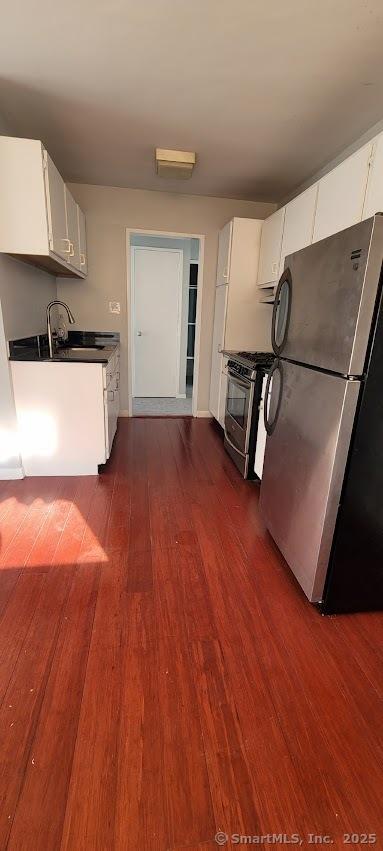 kitchen with white cabinetry, sink, dark wood-type flooring, and stainless steel appliances