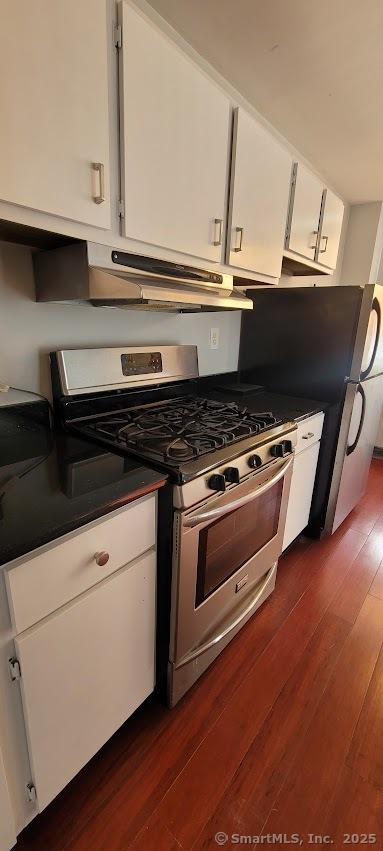 kitchen with white cabinetry, dark wood-type flooring, and stainless steel appliances