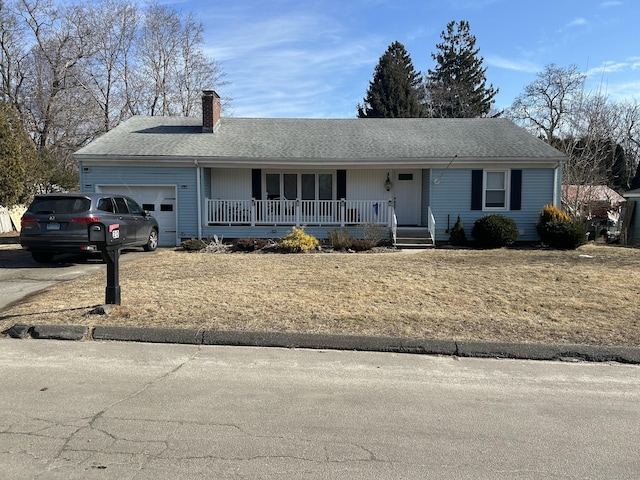 single story home with a garage and covered porch