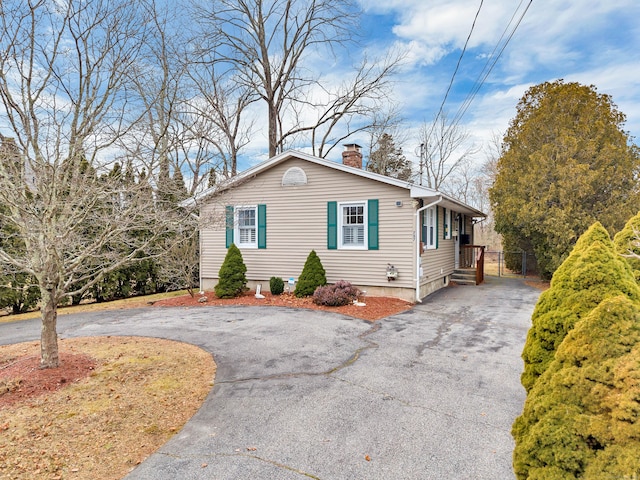 view of front of property with driveway and a chimney