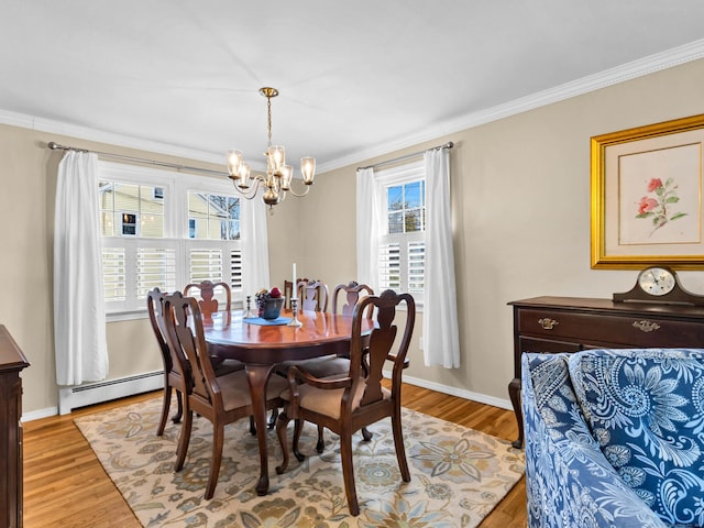 dining space featuring baseboards, a chandelier, light wood-type flooring, ornamental molding, and a baseboard radiator