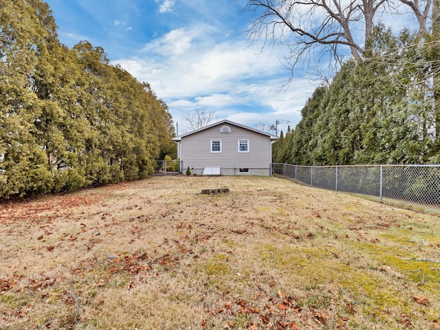 view of side of property featuring a yard and a fenced backyard