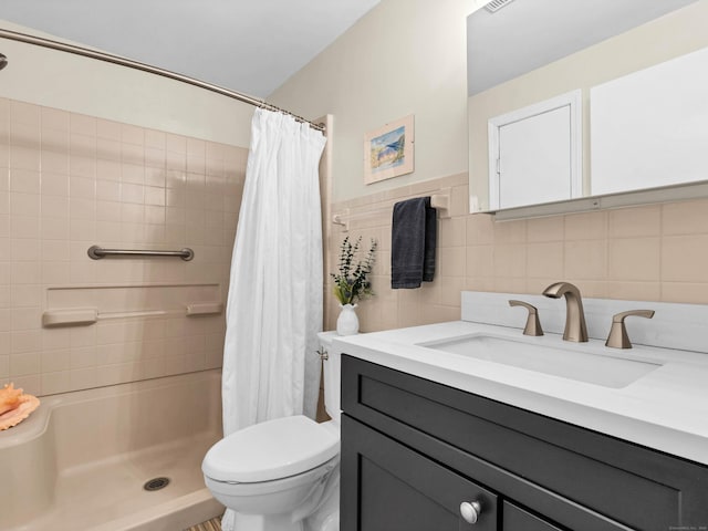 full bathroom with curtained shower, vanity, toilet, and tile walls