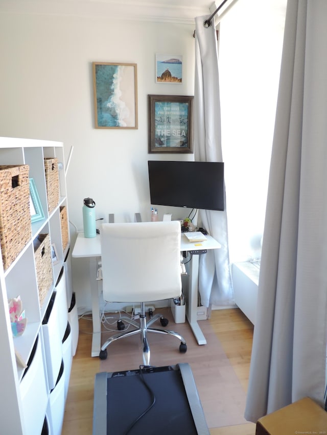 home office with light hardwood / wood-style flooring