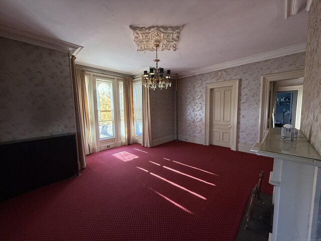 55 Walnut St, Winchester, CT 06098 - carpeted empty room with a notable chandelier and ornamental molding