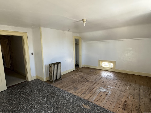 55 Walnut St, Winchester, CT 06098 - additional living space featuring vaulted ceiling, radiator heating unit, and hardwood / wood-style floors