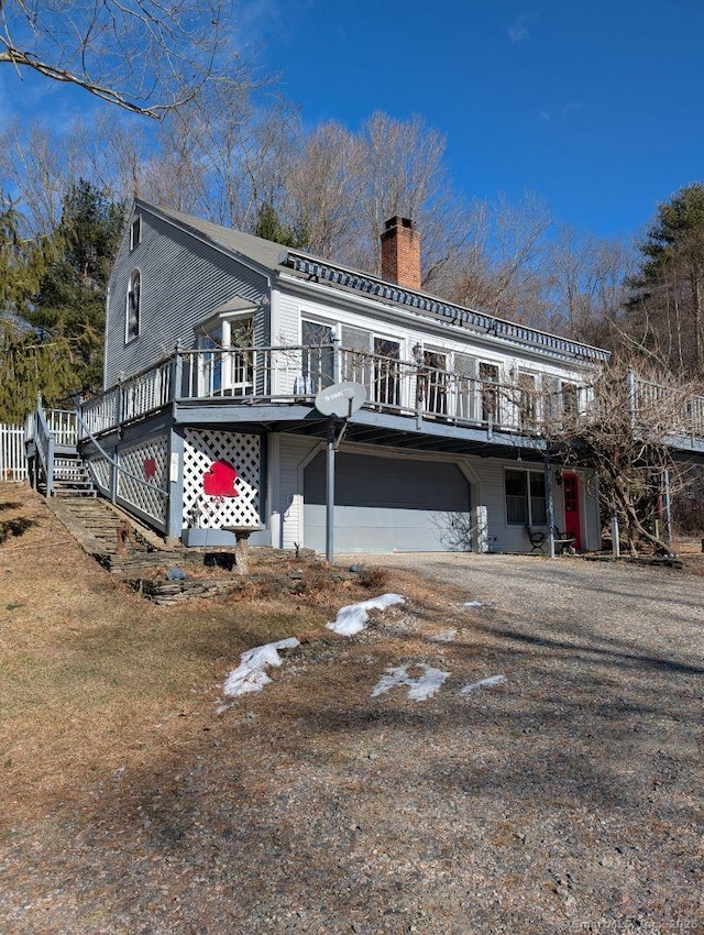 rear view of house featuring a wooden deck