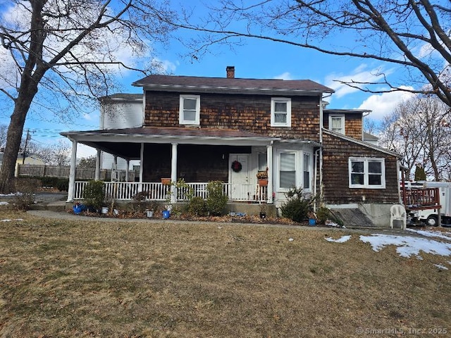 view of front of home with a front yard and covered porch