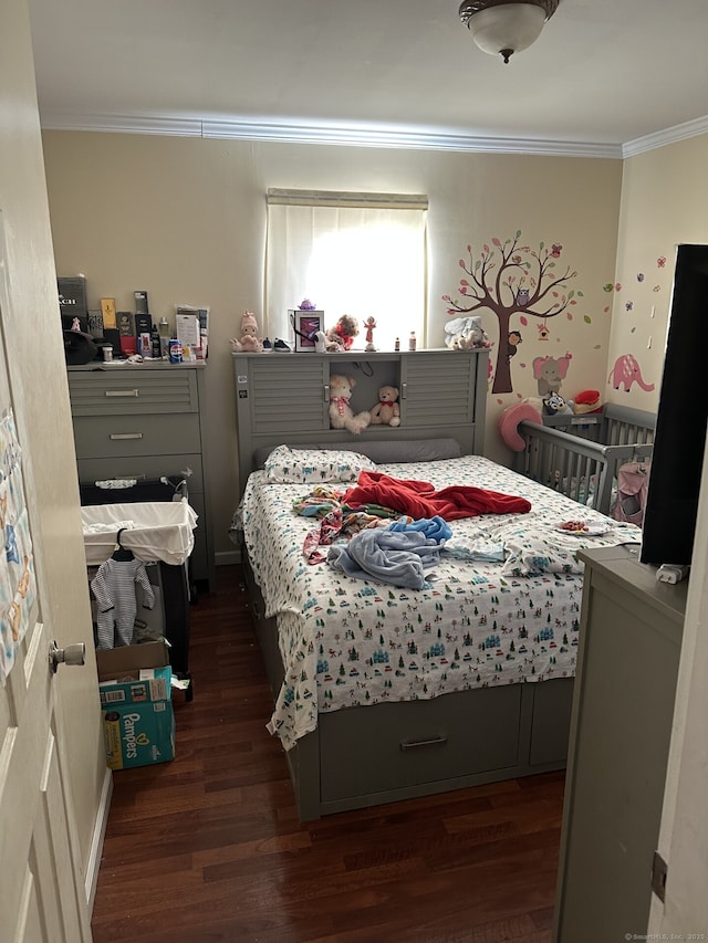 bedroom with crown molding and dark hardwood / wood-style floors