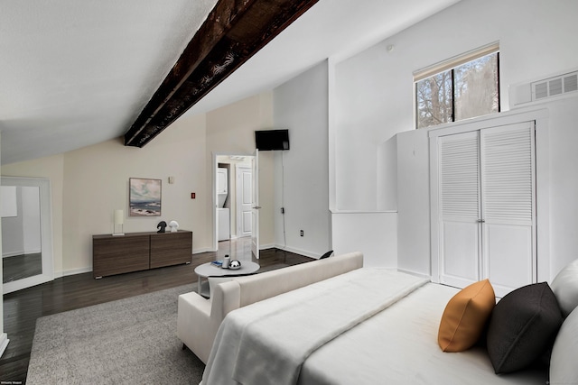 bedroom featuring lofted ceiling with beams, baseboards, wood finished floors, visible vents, and a closet
