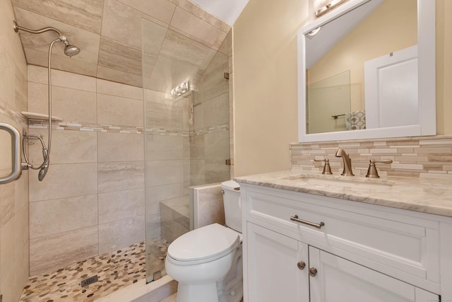 full bath featuring vanity, tasteful backsplash, a shower stall, and toilet