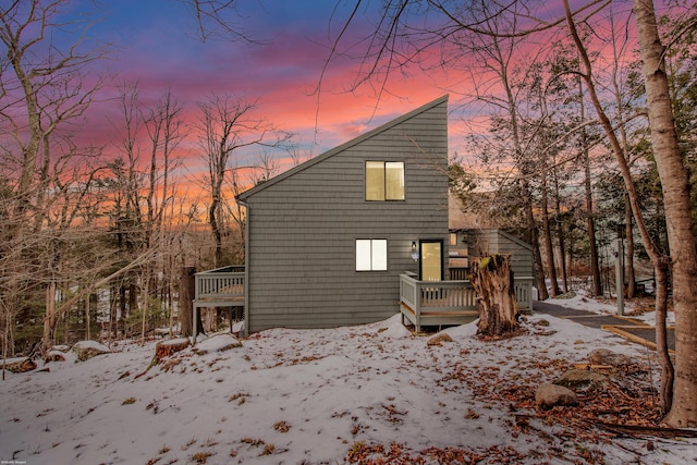 view of snow covered exterior with a wooden deck