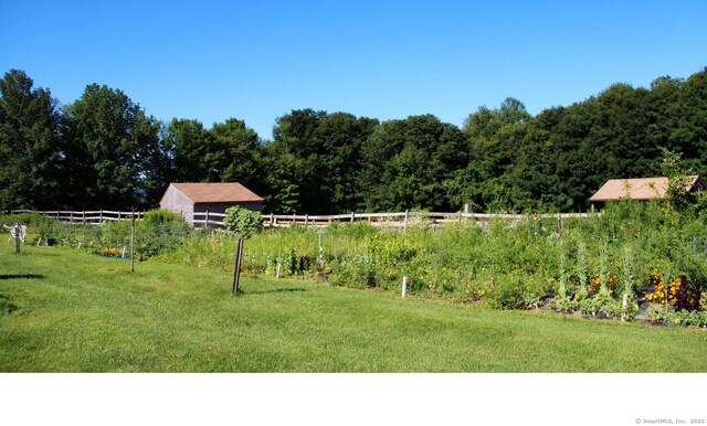 view of yard with a view of trees and fence