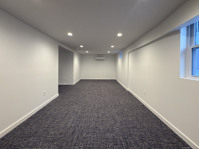 carpeted empty room with a wall unit AC