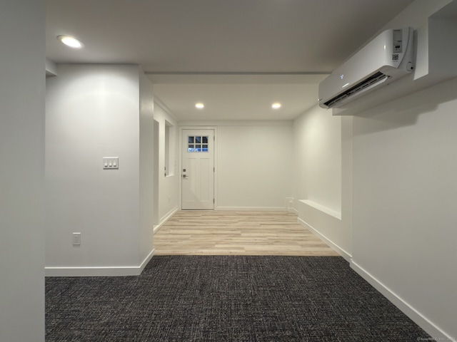 hallway with carpet and a wall unit AC