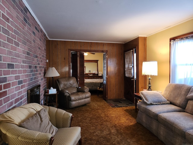 carpeted living room featuring a brick fireplace, crown molding, and wooden walls