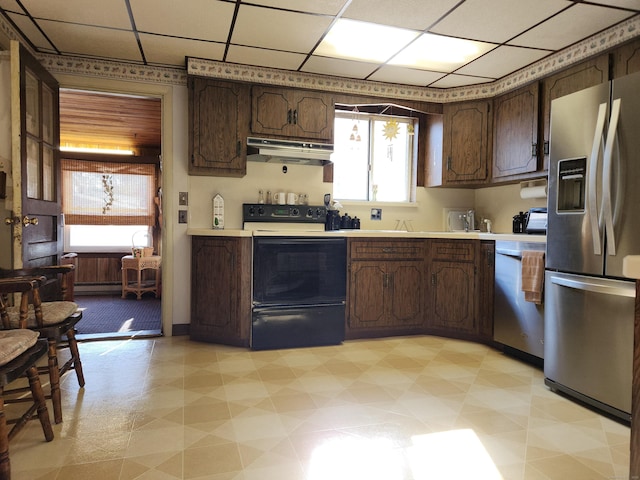 kitchen featuring a paneled ceiling, appliances with stainless steel finishes, and dark brown cabinets