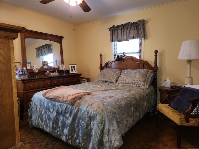 bedroom featuring ceiling fan and dark colored carpet