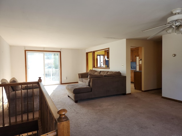 carpeted living room featuring ceiling fan