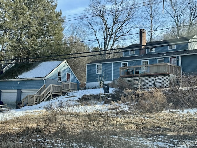 9 White Deer Rocks Rd, Woodbury, CT 06798 - snow covered house featuring a wooden deck, a chimney, and a garage