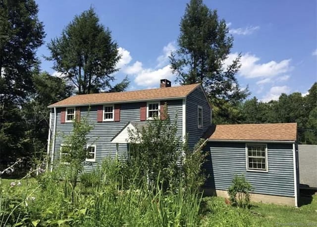view of home's exterior with a chimney