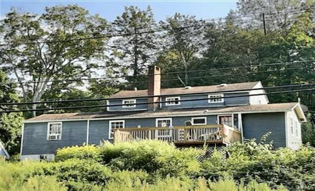 back of property featuring a wooden deck