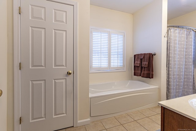 bathroom with tile patterned flooring, vanity, and a washtub