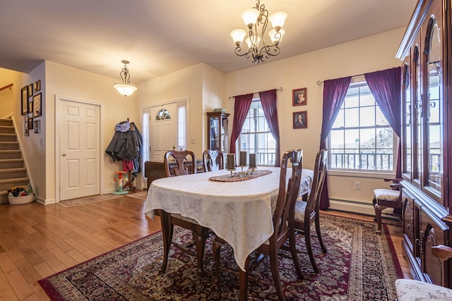 dining room featuring a baseboard radiator, dark hardwood / wood-style flooring, and a notable chandelier