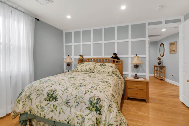 bedroom with hardwood / wood-style flooring