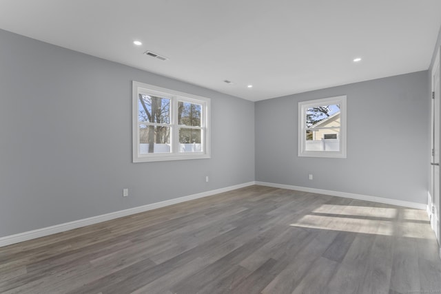 unfurnished room featuring hardwood / wood-style flooring