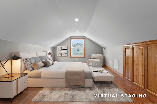 bedroom featuring wood-type flooring and vaulted ceiling