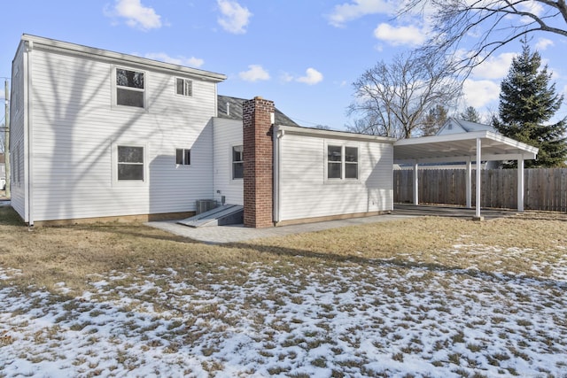 snow covered property featuring central AC