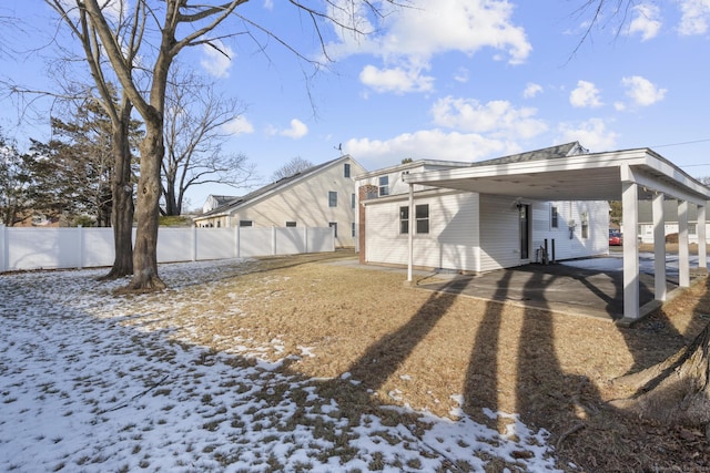 snow covered property with a carport