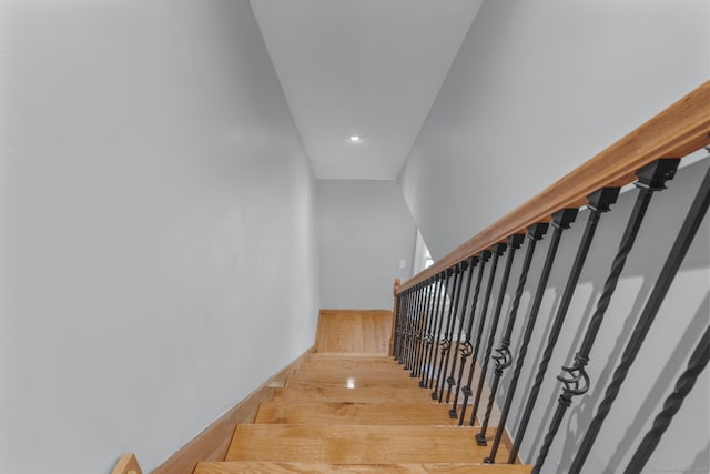 stairs featuring wood-type flooring