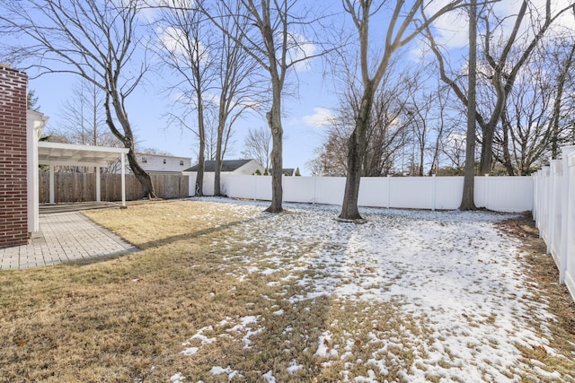 yard layered in snow with a patio