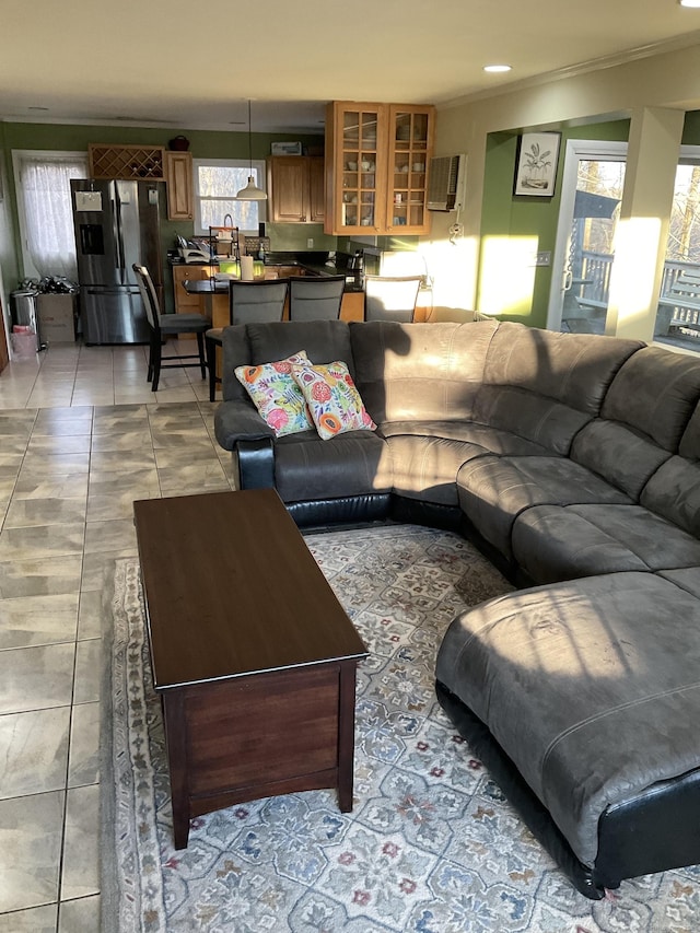 living room featuring ornamental molding and light tile patterned floors