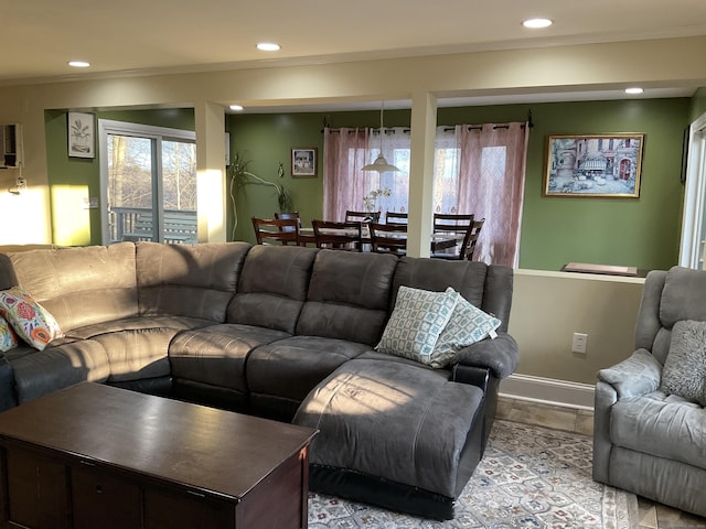 living room featuring crown molding and plenty of natural light