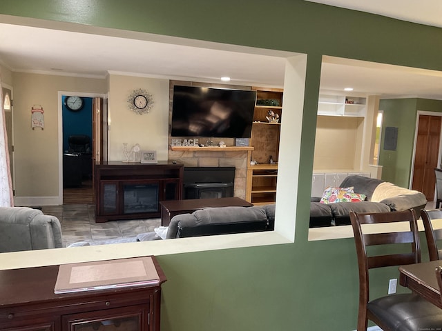 living room with built in shelves and ornamental molding