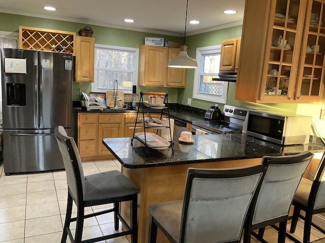 kitchen with a breakfast bar, crown molding, decorative light fixtures, appliances with stainless steel finishes, and kitchen peninsula