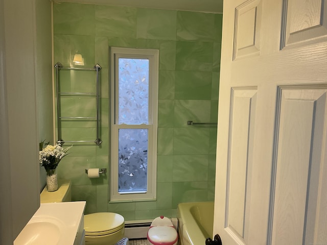 bathroom with toilet, tile walls, vanity, a bathing tub, and a baseboard heating unit