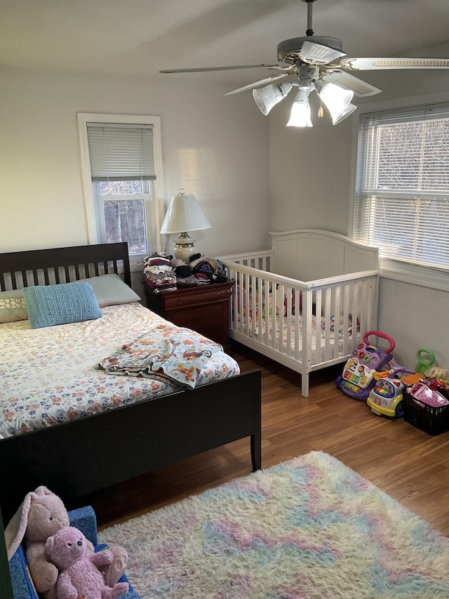 bedroom with wood-type flooring and ceiling fan