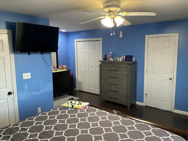 bedroom with ceiling fan, dark hardwood / wood-style flooring, and a closet