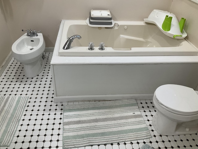 bathroom featuring tile patterned flooring, a bidet, and toilet