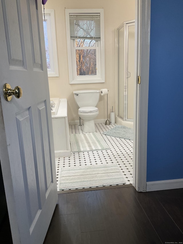 bathroom with walk in shower, vanity, tile patterned floors, and toilet