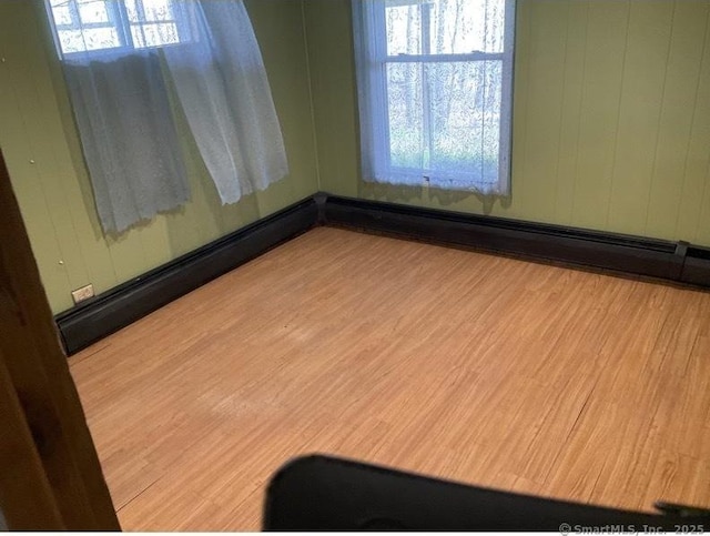 empty room featuring light hardwood / wood-style flooring and a healthy amount of sunlight