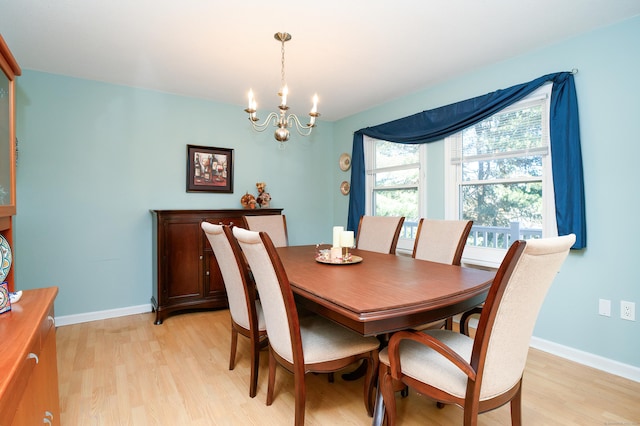 dining area with a chandelier and light hardwood / wood-style flooring