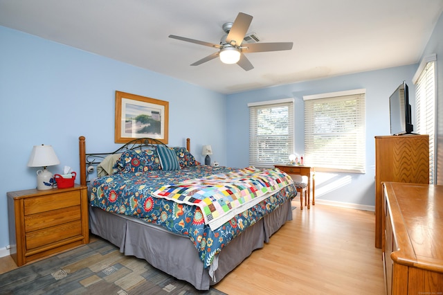 bedroom with hardwood / wood-style flooring and ceiling fan