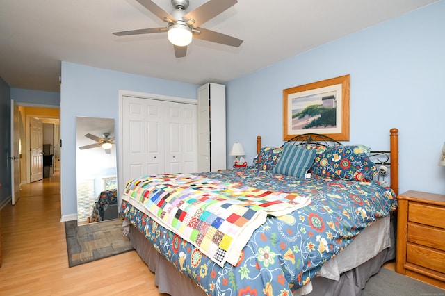 bedroom featuring ceiling fan, light hardwood / wood-style floors, and a closet