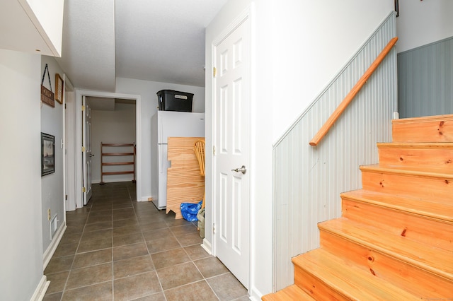 stairway featuring tile patterned floors